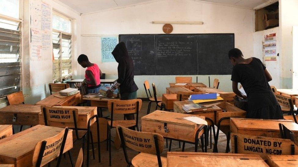 School children pack their books to take home, following a directive by the Kenyan government to suspended learning in all institutions of learning as a preventive measure against the spreading of the COVID-19 coronavirus, on March 16, 2020, in Nairobi