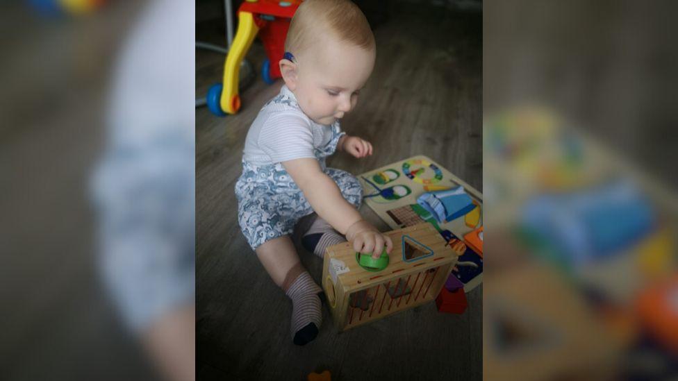 Mason playing with toys