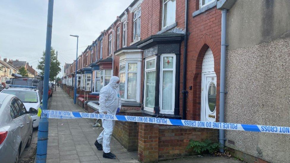 Hazmat-suited officer entering the property