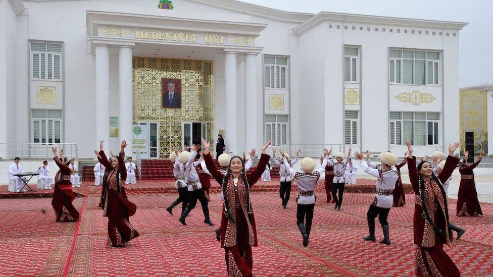 Folk artists perform in front of a polling station during the presidential election in Ashgabat on March 12, 2022