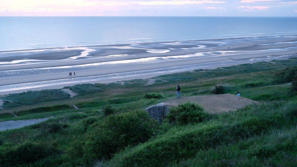 man-looking-out-over-Omaha-Beach.