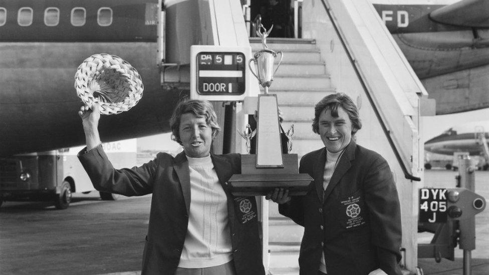 Cricketers Rachael Heyhoe Flint (left) and Lynne Thomas at London Airport (now Heathrow) on their return from the West Indies, 4 March 1971. They are holding the Pearl And Dean Cricket Trophy for competition between the English and West Indies Ladies' teams.