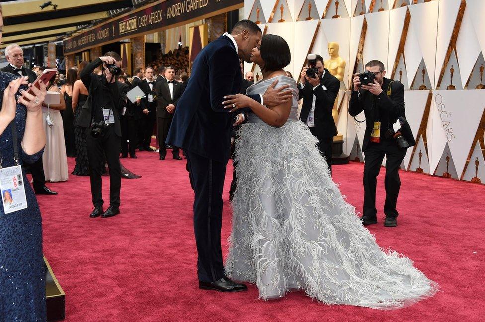 Michael Strahan, left, and Octavia Spencer embrace