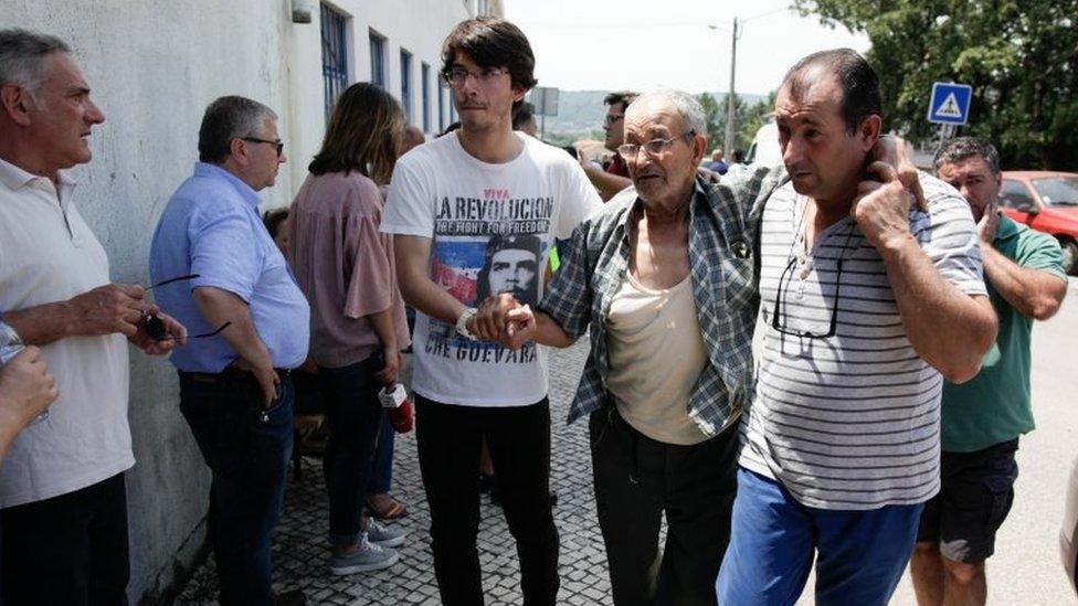 An unidentified victim of the forest fires in central Portugal is helped upon is arrival at Atleco Clube Avelarense, in Avelar, Portugal, 18 June 2017.