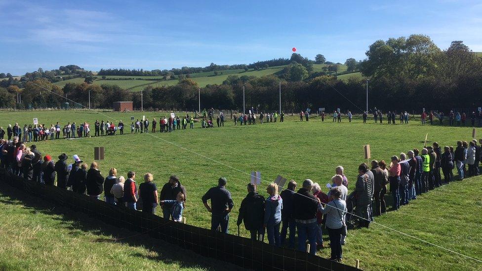 Protesting villagers gathered around a football pitch in Abermule