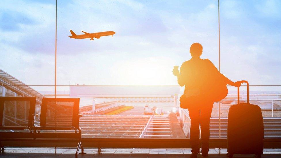 Woman looking at a plane in an airport