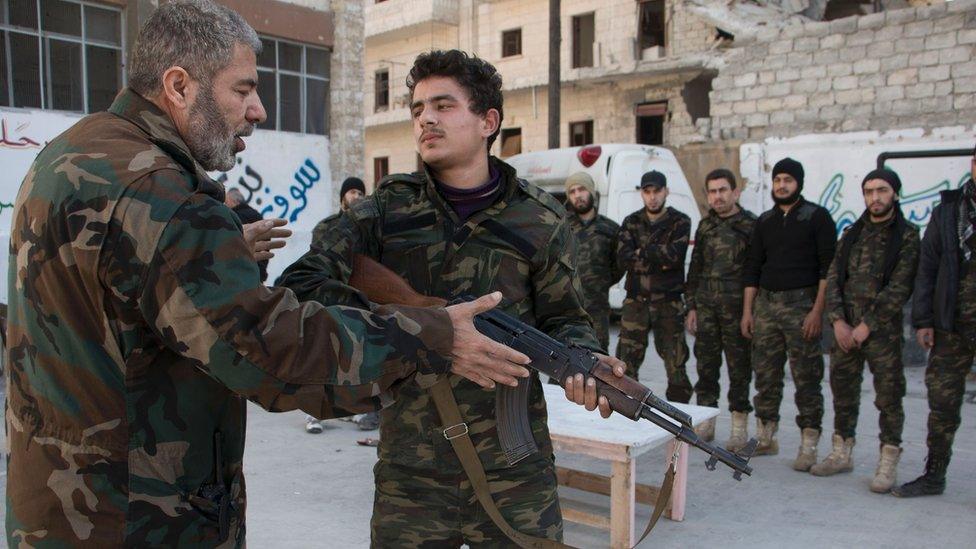 New recruits take part in a shooting training session on February 16, 2016 at a camp in a rebel-held area of the northern city of Aleppo before fighting along with opposition fighters