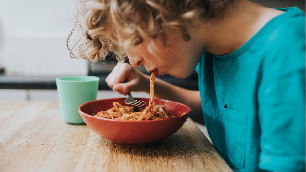 Child eating meatballs