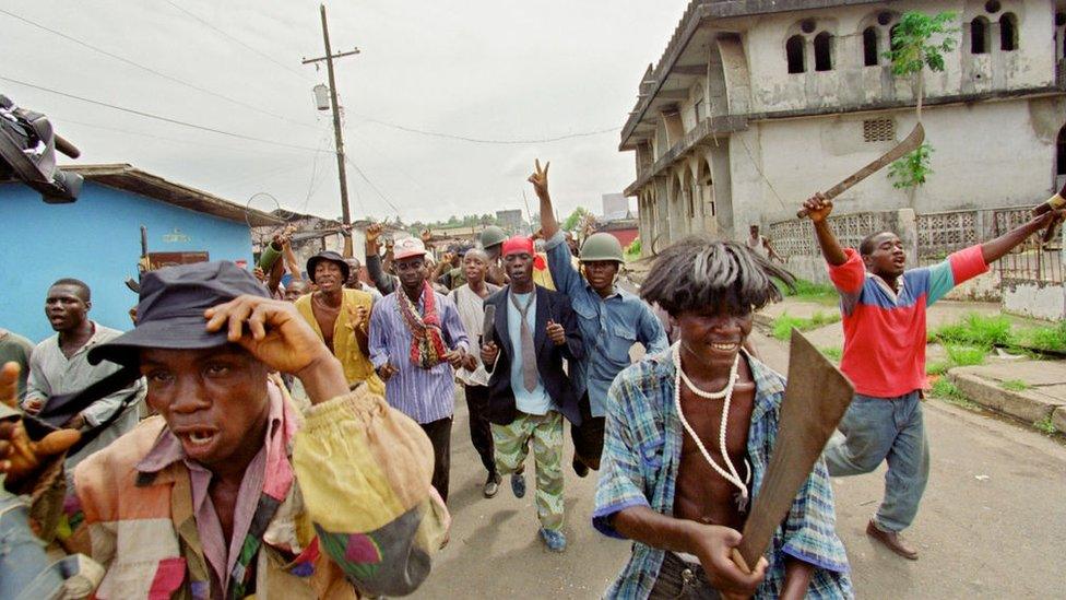 Militiamen of National Patriotic Front of Liberia in the streets.