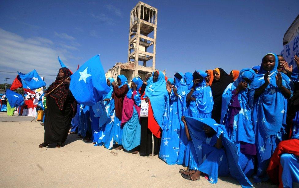 Residents dressed in national colours attend Independence day celebrations outside the ruins of the former Parliament buildings in Mogadishu, Somalia July 1, 2016