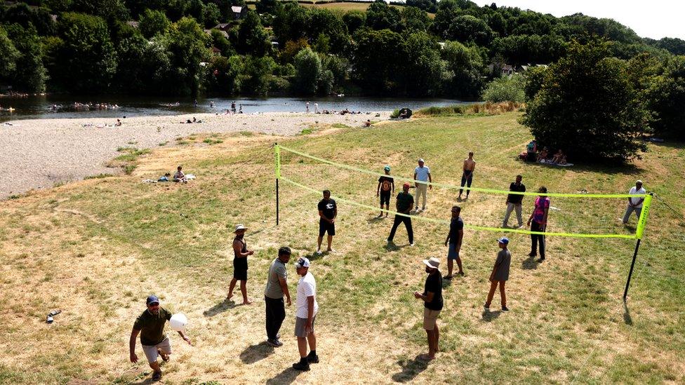 People play in the Wye at Glasbury