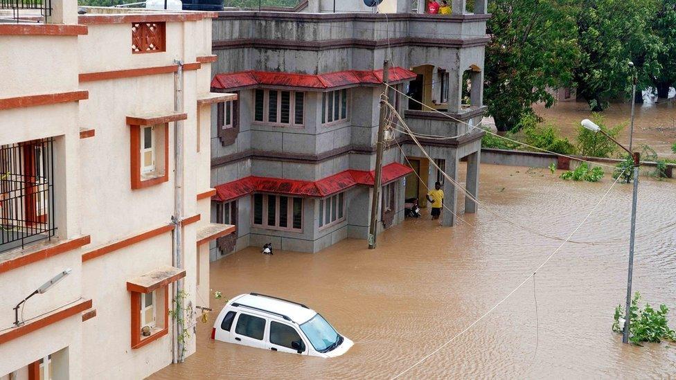 Flood water surrounding buildings in India