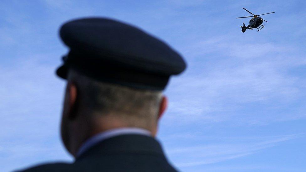 A helicopter from RAF Shawbury takes part in a ceremonial fly-past during the funeral of World War II veterans Victor Barnett and his wife Edna at Telford Crematorium