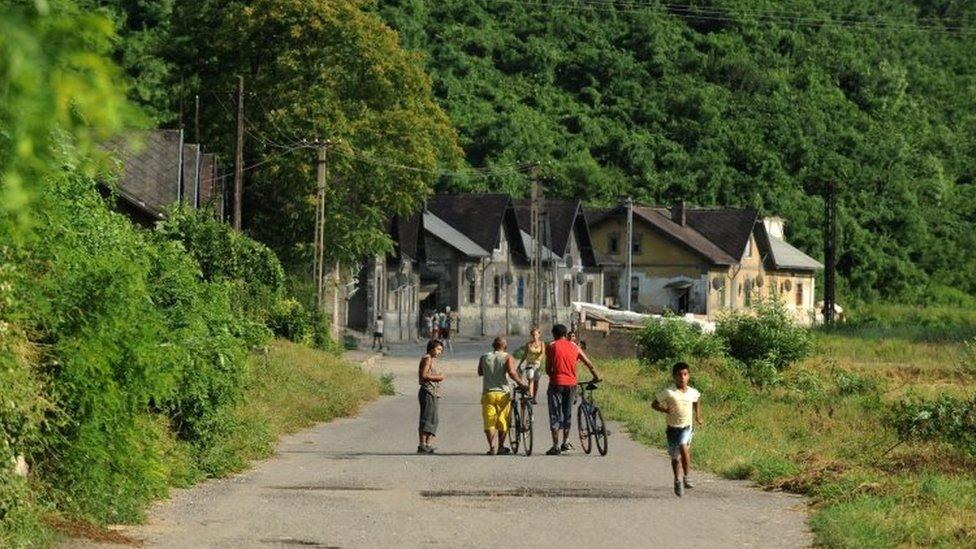 People walk in a street in the Hetes borough of Ozd, 153km north-east of Budapest