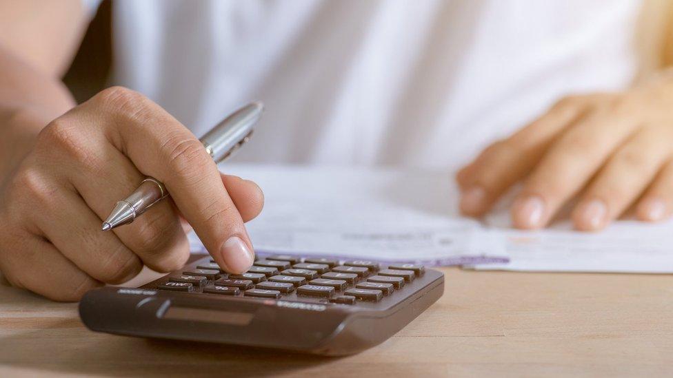 Woman using calculator