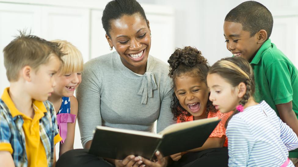 Woman reading to children