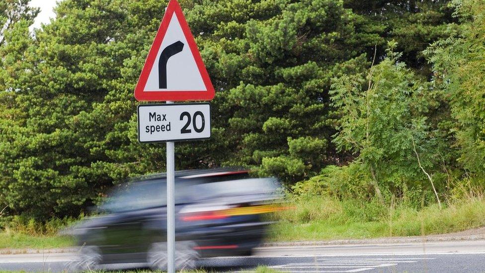 Car speeding past 20mph sign