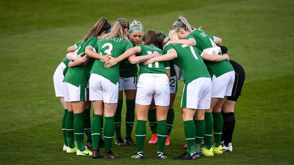 Female players in a huddle