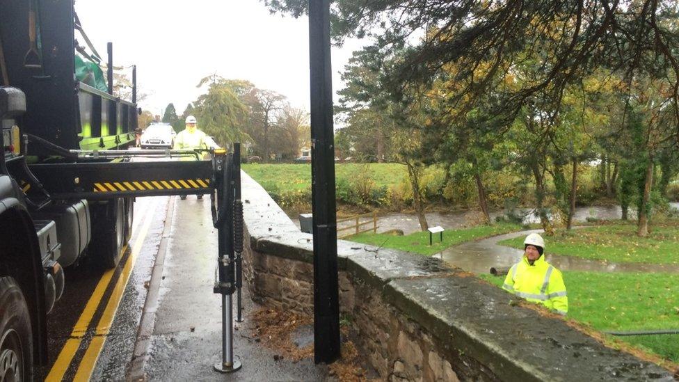 NRW staff working on flood defences in St Asaph