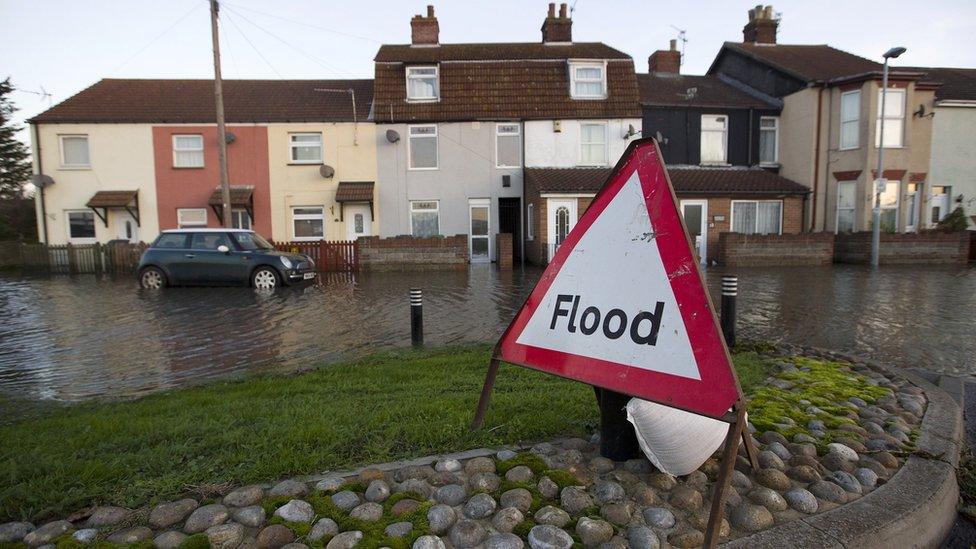 A flood warning sign displayed on a street where flood waters rose to the front doors of houses, in Great Yarmouth on 6 December 2013