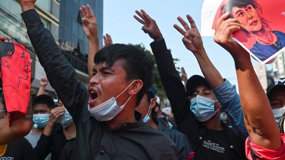 People show the three-finger salute as they rally in a protest against the military coup and to demand the release of elected leader Aung San Suu Kyi, in Yangon, Myanmar, February 8, 2021.