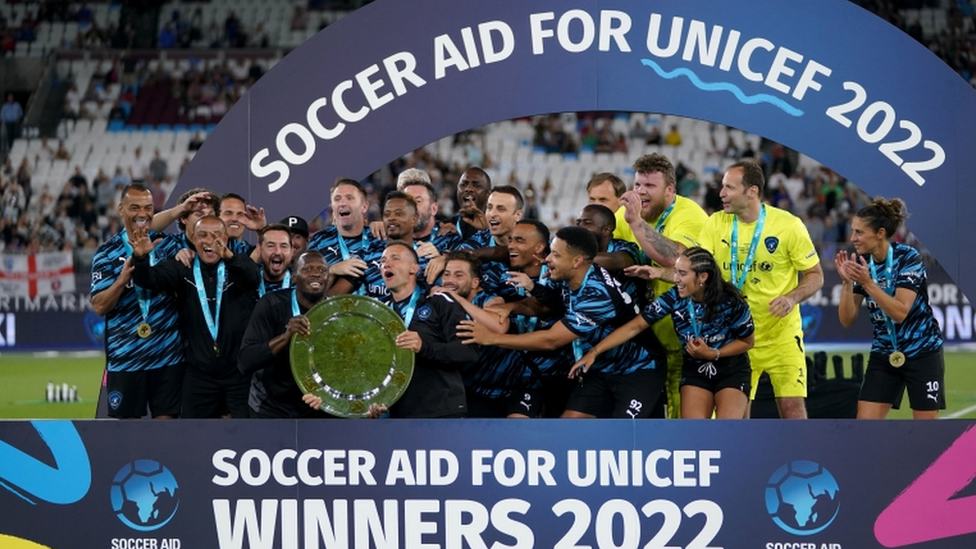 Rest of the World XI players celebrate with the trophy after the Soccer Aid for UNICEF match