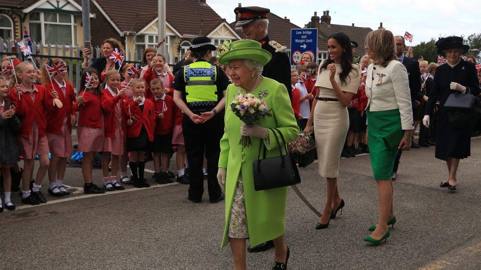 Queen and Meghan waving at crowds in Runcorn