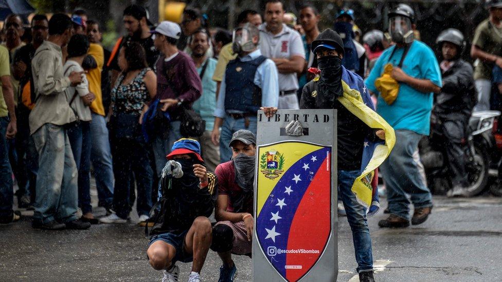 Demonstrators block an avenue during an anti-government protest in Caracas on June 29, 2017