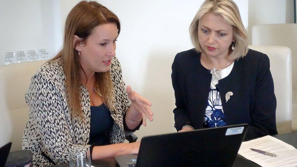 Dr Faye Kirkland speaking to Prof Helen Stokes-Lampard, looking at a laptop.