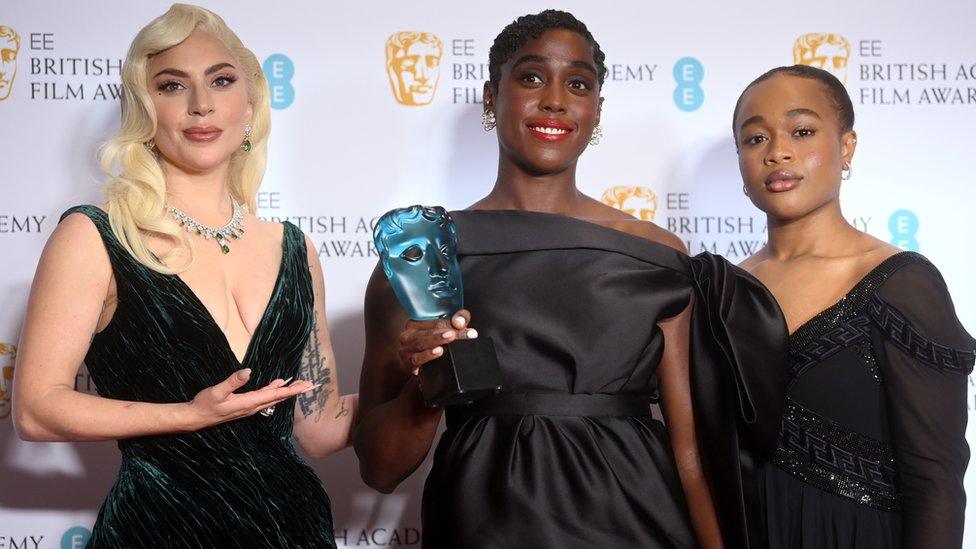 Lady Gaga (L) and last year's winner Bukky Bakray (R) present the rising star prize to Lashana Lynch