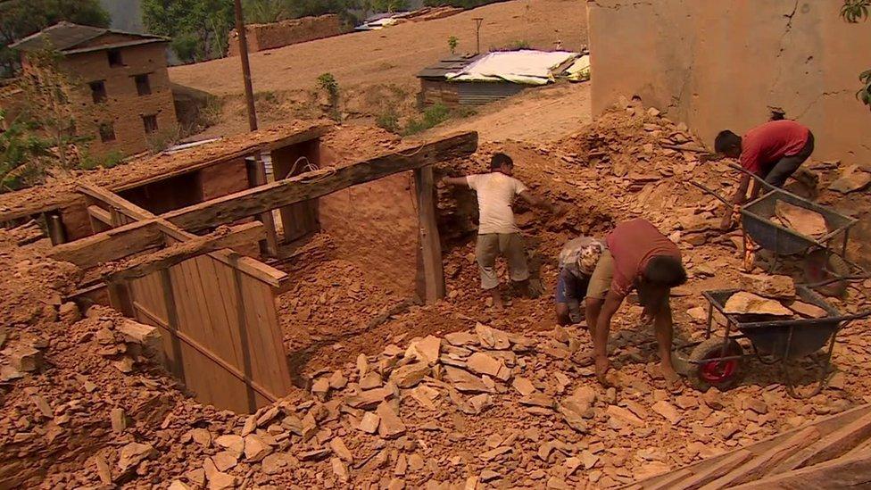 People clearing rubble