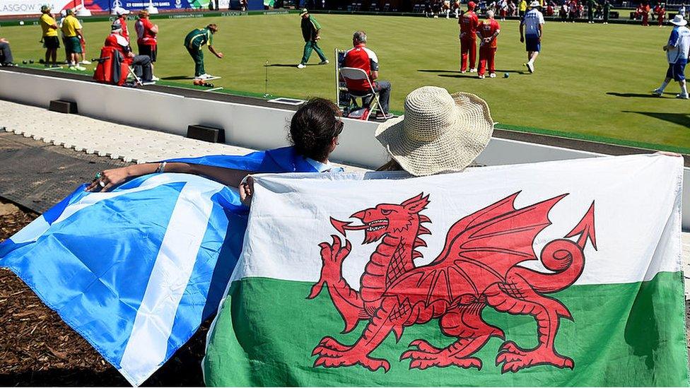 Fans holding a Scottish and Welsh flag attend Kelvingrove Lawn Bowls Centre during day one of the Glasgow 2014 Commonwealth Games