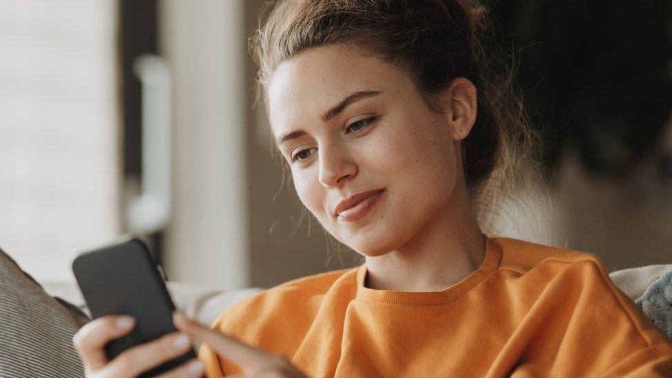 Woman looks at phone