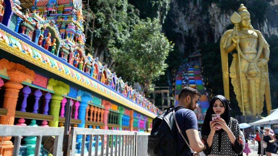 Visitors near the colourful stairs at Malaysia's Batu Caves