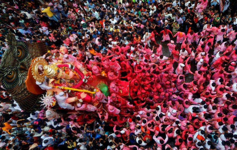 Devotees carry the idol of Hindu god Ganesh, the deity of prosperity, through a street on the last day of the ten-day-long Ganesh Chaturthi festival in Mumbai, India, 15 September 2016.