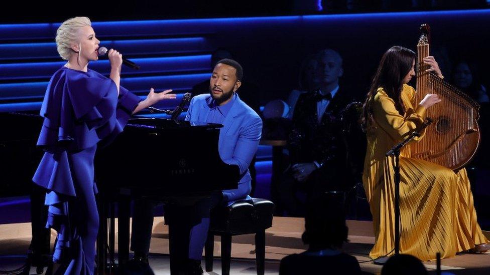 (Left to right) Mika Newton, John Legend, and Siuzanna Iglidan performed onstage during the 64th Grammy Awards at the MGM Grand in Las Vegas on Sunday