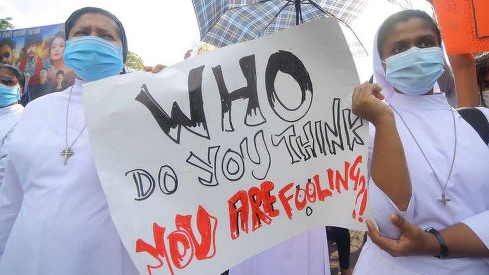 Sri Lankan catholic nuns hold placards during a protest at Colombo, Sri Lanka. Monday, 4 April 2022.