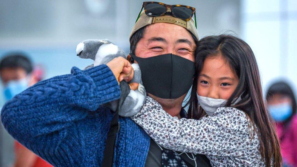 Passengers greet family members after landing from Singapore Airlines flight number 231 at Sydney Airport on November 21, 2021 in Sydney, Australia.