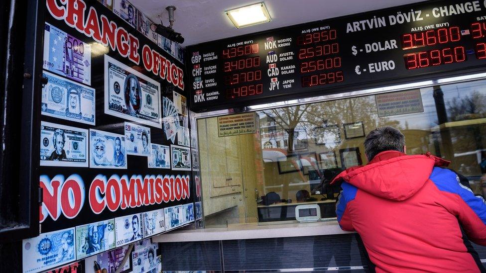 A man changes money at a change office in Istanbul