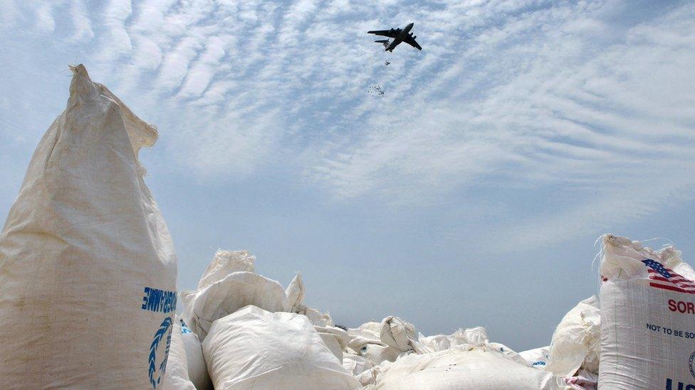 An airplane carries out an food-drop over a field at a village in Nyal, an administrative hub of Panyijar county in Unity state, south Sudan