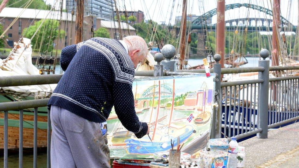 Man painting tall ship scene