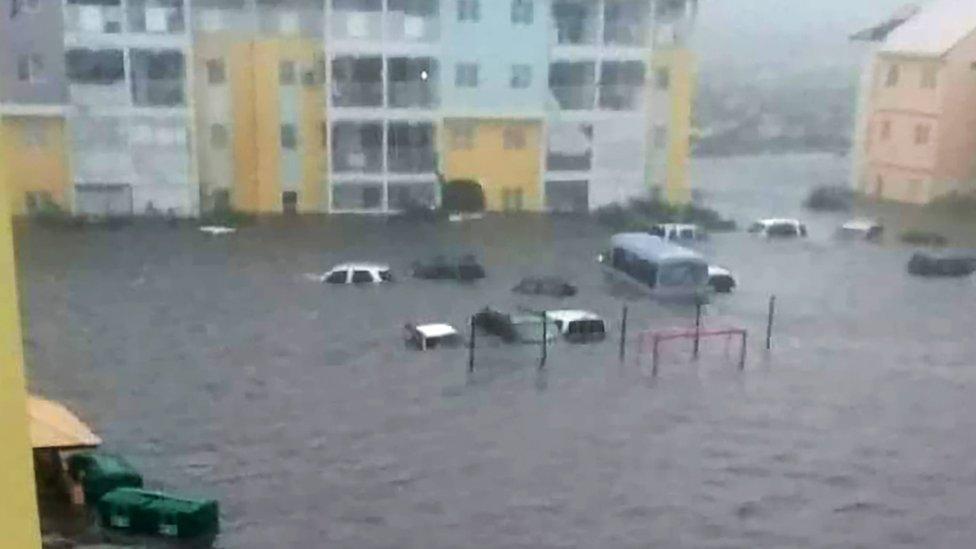 Cars floating outside building