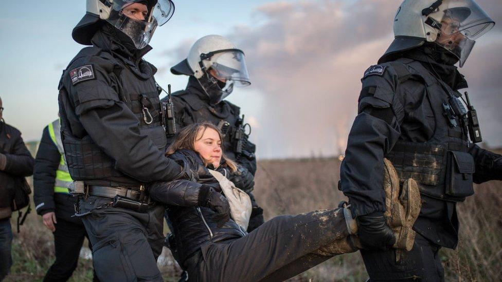Greta being carried by police
