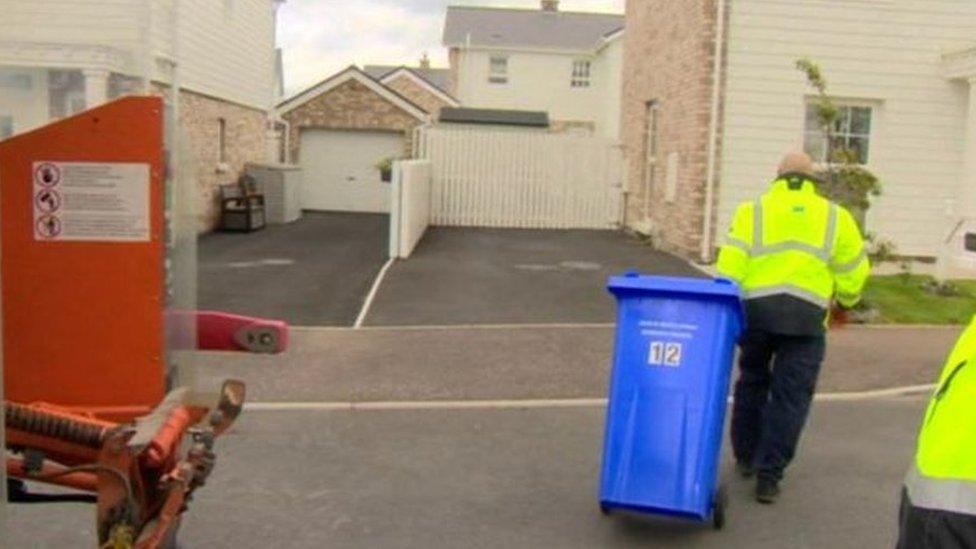 Blue bins being moved