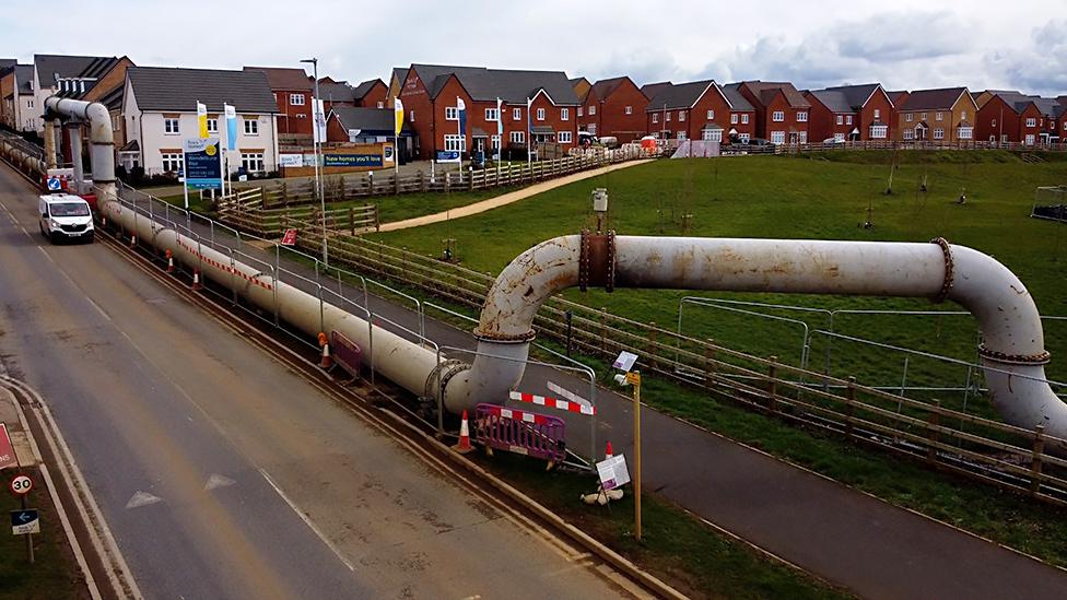 Temporary above-ground sewage pipe in Wellingborough