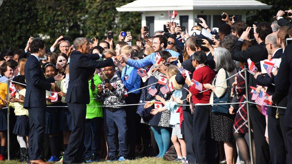 US President Barack Obama and Canada"s Prime Minister Justin Trudeau greet the crowd during a welcome ceremony during a State Visit on the South Lawn of the White House on March 10, 2016 in Washington, DC