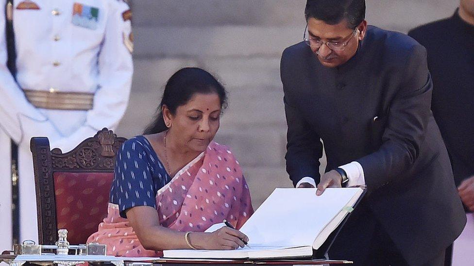 The Bharatiya Janata Party's Nirmala Sitharaman signs papers after taking oath as a cabinet minister during the swearing-in ceremony on May 30, 2019 in Delhi, India