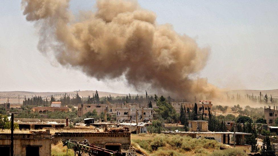 Smoke rises above a rebel-held part of Deraa after an air strike by Syrian government forces (26 June 2018)