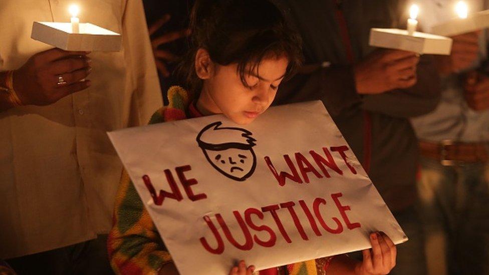 A third generation gas victim holds a placard during a candlelight vigil held by various gas victim organisations to commemorate Bhopal gas disaster in Bhopal on 1 December 2018.