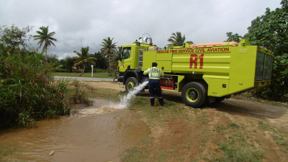 The island's fire brigade topping up Trevor's puddle